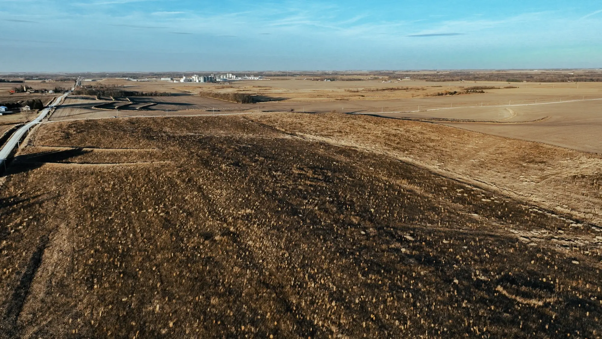 a bird's eye view of farmland in Butler County, Iowa. The sky is clear.