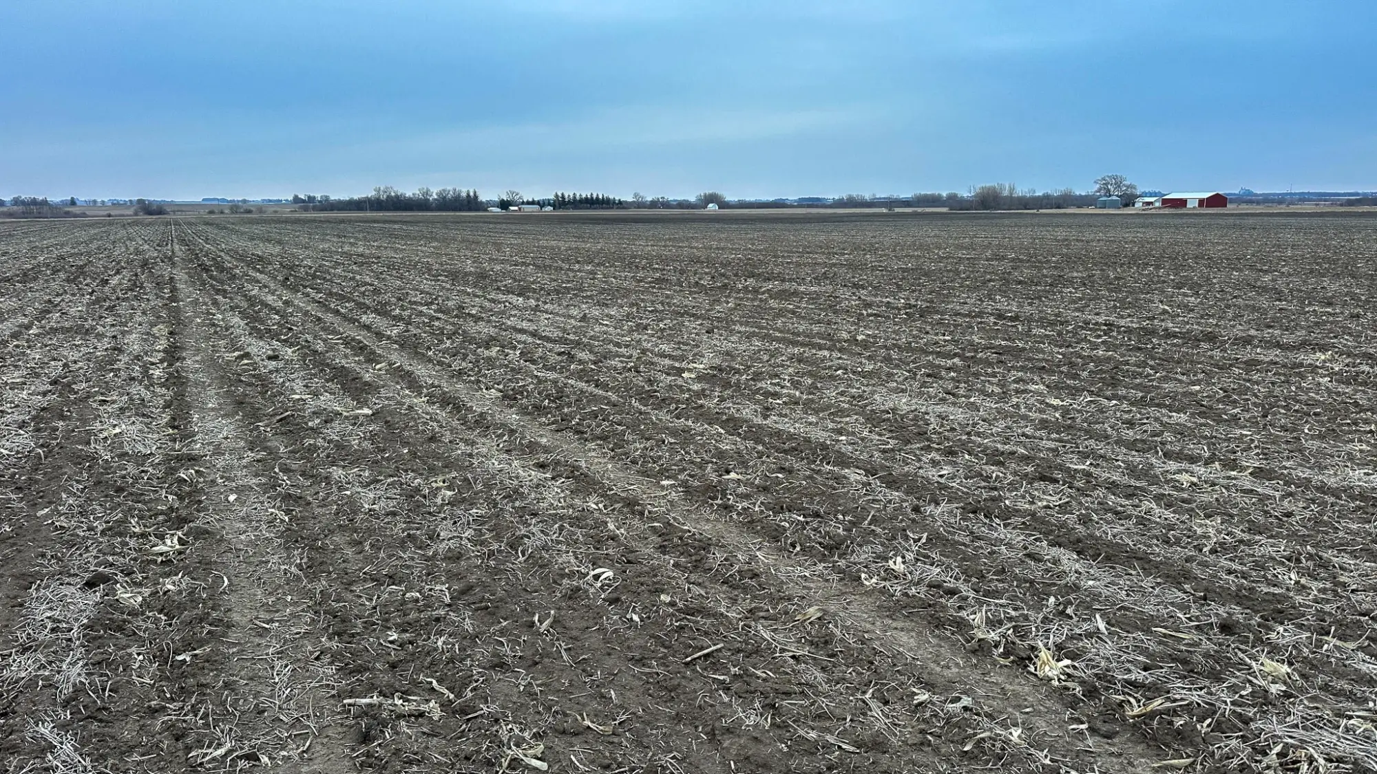a photo of a bird's eye view of Cerro Gordo County, Iowa farmland. The sky is blue and cloudy.