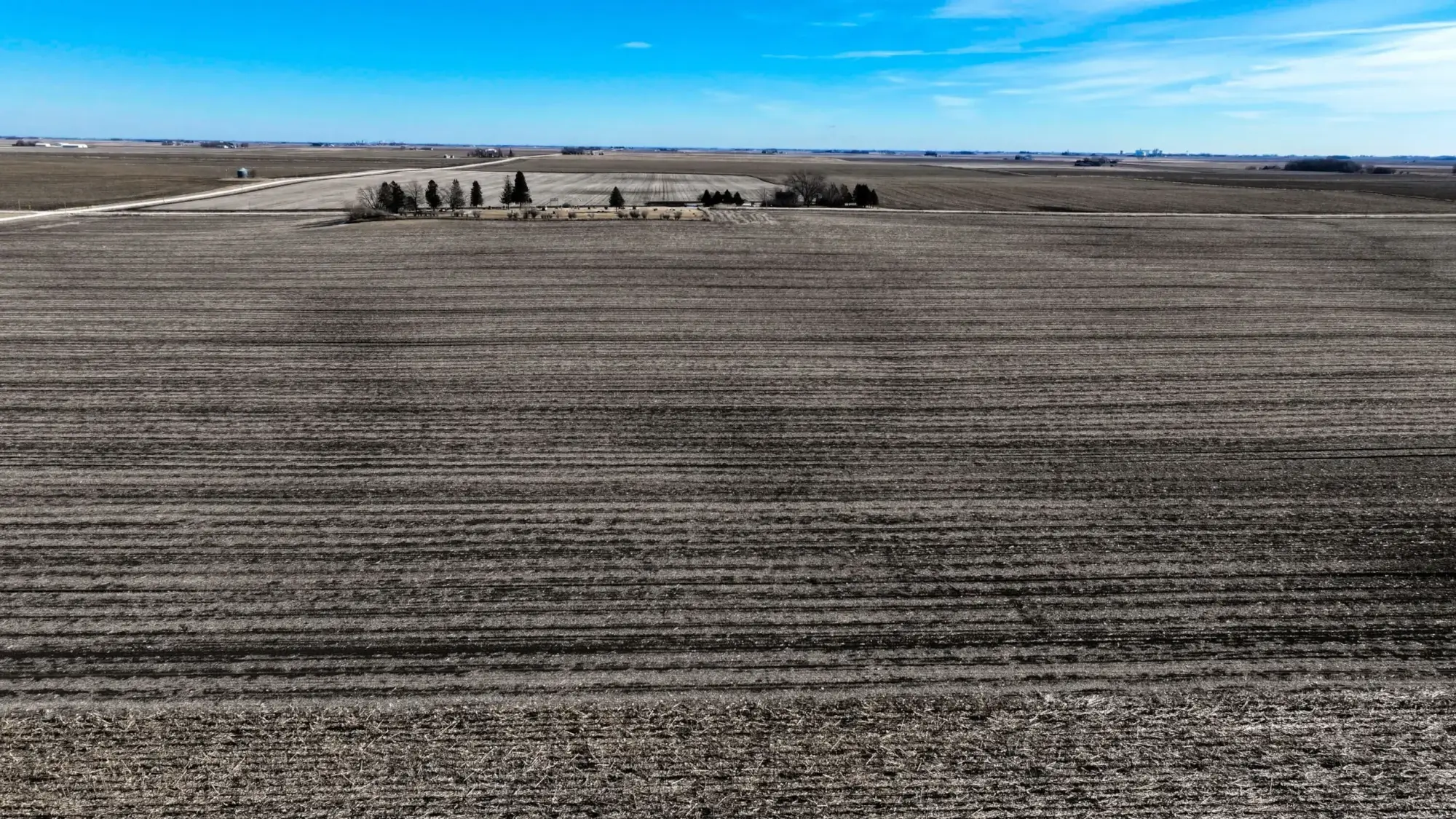 a photo of a bird's eye view of webster County, Iowa farmland. The sky is bright blue with a few clouds.