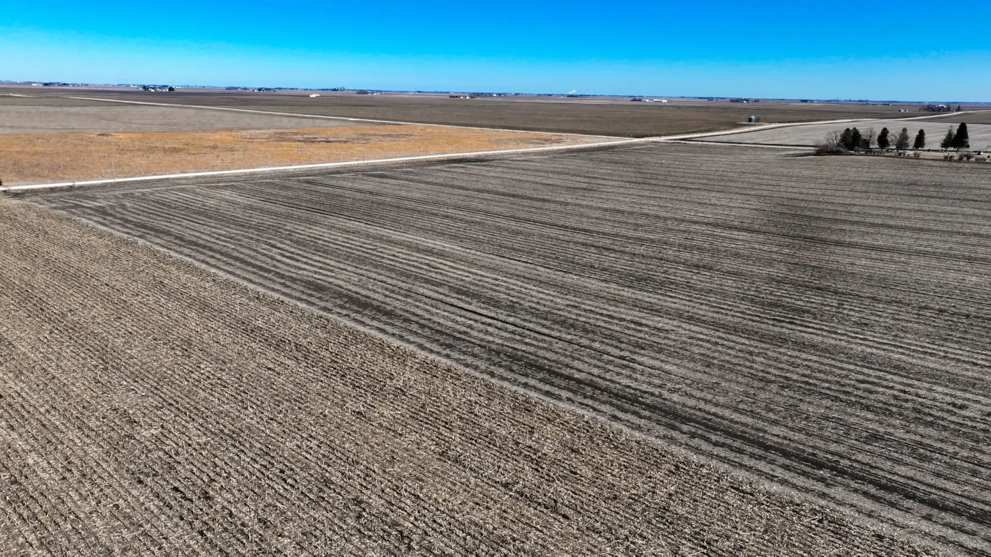 a photo of a bird's eye view of webster County, Iowa farmland. The sky is bright blue with a few clouds.